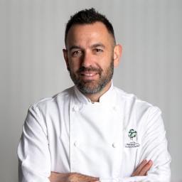 Professional headshot of Head Chef Massimo Rossi, wearing a chef's jacket